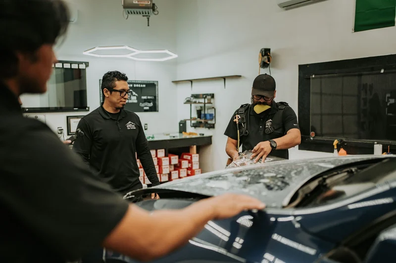 Team participating in STEK paint protection film training and application